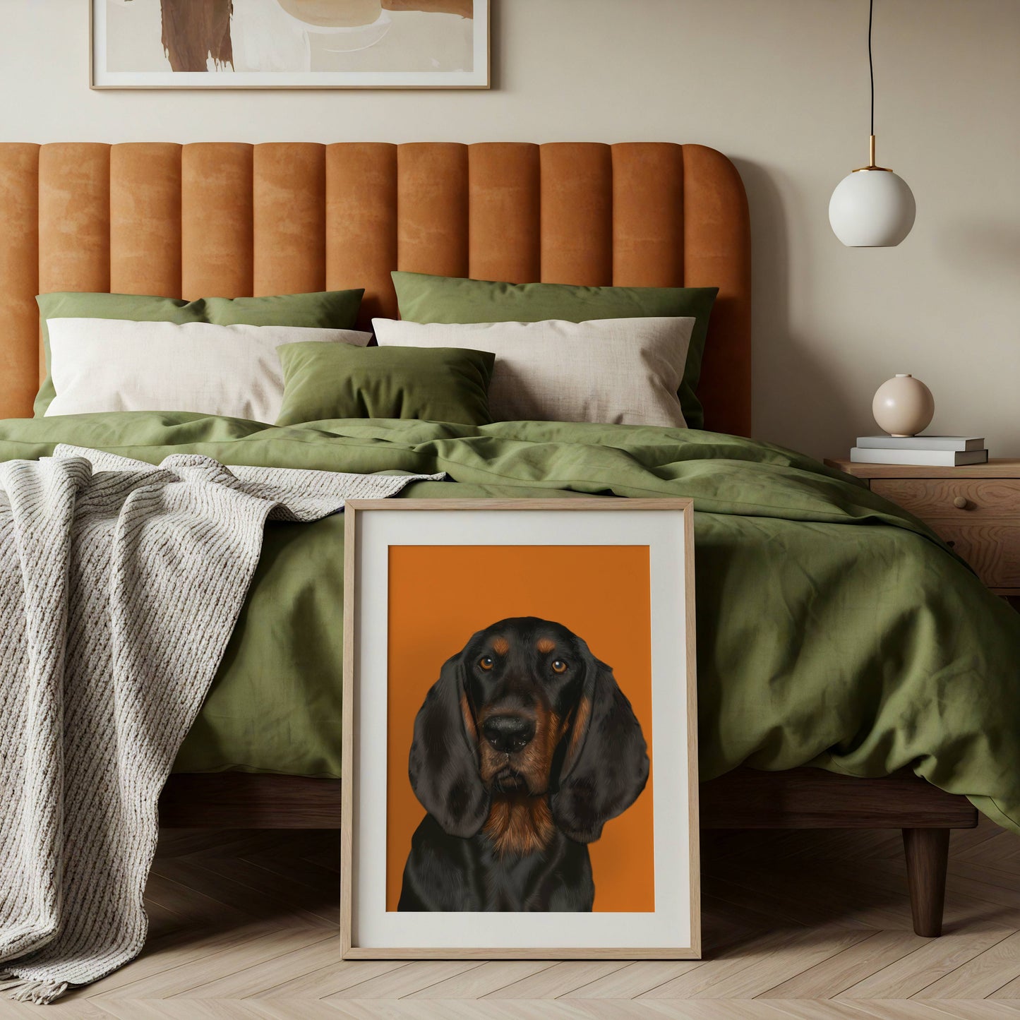 Framed artwork of a coonhound dog on a bed with green bedding and an orange headboard.